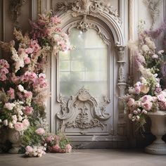 there are many flowers in vases next to the wall with an ornate frame on it