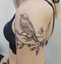 a woman with a bird tattoo on her shoulder