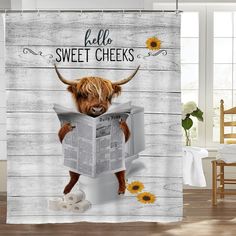 a shower curtain with a cow reading a newspaper and sunflowers on the floor