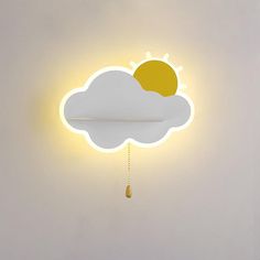 a yellow and white clock with a cloud on it's face, hanging from the ceiling