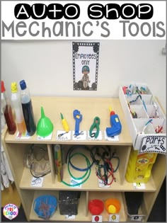 a wooden shelf filled with lots of toys and supplies on it's sides, in front of a white wall that says auto shop mechanic's tools