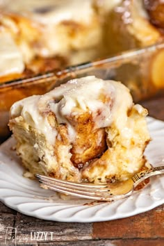 a piece of cinnamon roll on a plate with a fork