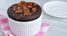 a chocolate fudge mug brownie sitting on top of a pink and white napkin