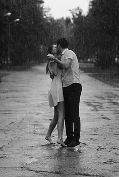 a man and woman kissing in the rain