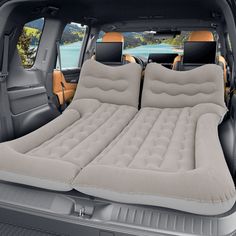 an inflatable car bed is placed inside the back of a vehicle with two seats