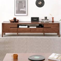 a living room with a coffee table and record player on the shelf next to it