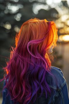 Blending from fiery red to deep purple, this sunset ombre hair mimics the evening sky, offering a beautiful and captivating look for festival evenings. Ombre Rainbow Hair, Ombre Hair Color Vivid, Sunrise Hair Color Ombre, Colourful Dyed Hair, Purple Hair With Lavender Highlights, Sunset Hair Color Ombre Purple, Purple Sunset Hair, Dark Sunset Hair, Colorful Hair Styles