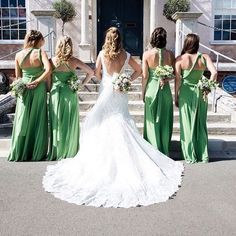 a bride and her bridesmaids in green dresses