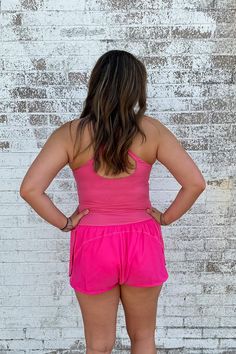 This Athletic Cut Out Romper in Pink offers a winning combination of style and comfort. It's made from a soft blend of nylon and spandex, so you can be agile without sacrificing on fashion. Perfect for casual days and athleisure, the criss cross straps and small cut-out under the chest make sure you're turning heads - in all the right ways. Get fit in style! Model is wearing a size medium. Stocked at Arlington Village and Uptown. Casual Compression Tank Top With Built-in Bra, Spring Sports Tank Top With Built-in Bra, Pink Nylon Activewear With Go-dry Technology, Fitted Mesh Activewear For Spring, Spring Workout Activewear With Built-in Bra, Spring Sporty Racerback Activewear, High Stretch Nylon Tank Top For Athleisure, Sleeveless Nylon Activewear For Summer, Sporty Racerback Activewear For Spring