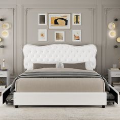 a white bed sitting in a bedroom next to two nightstands with lamps on them