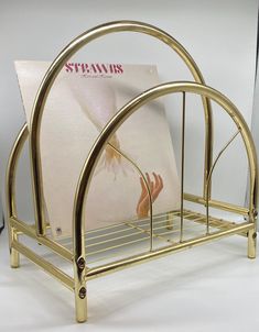 a magazine rack with magazines on it and a white wall in the backround