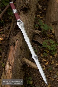 a large knife sitting on top of a tree stump