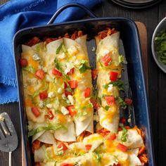 a casserole dish with tortilla shells and vegetables