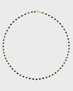 A stunning piece handcrafted with precision in New York City showcasing a series of perfectly round black onyx inlays, each encased in gleaming gold circles. The inlay technique is made in Italy and finished in New York City from our Marquet collection. Black Onyx 14 Karat Gold 15.5 to 17.5 inches Handmade in NYC Black Onyx Jewelry With Polished Beads, Fine Jewelry Onyx With Black Diamonds, Fine Jewelry With Black Diamonds And Onyx, Modern Onyx Jewelry With Black Beads, Luxury Onyx Round Bead Jewelry, Classic Black Jewelry With Round Stone, Modern Jewelry With Round Black Diamonds, Modern Jewelry With Black Diamonds, Modern Black Diamond Round Jewelry