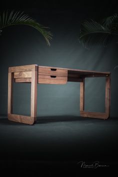 a desk made out of wood with two drawers on the top and one drawer at the bottom