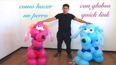 a man standing next to two balloons shaped like dogs