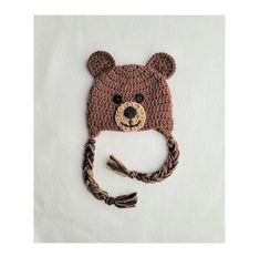 a crocheted brown bear hat on top of a white sheet