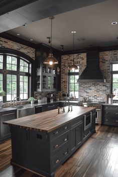 a large kitchen with an island in the middle and lots of windows on both sides