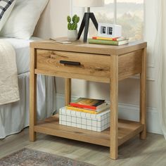 a nightstand table with books and a clock on it