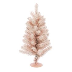 a small white christmas tree in a pink vase