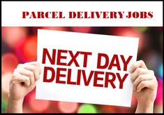 a person holding up a sign with the words next day delivery in red on it