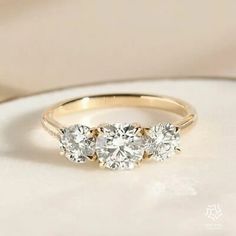 three stone diamond ring in yellow gold