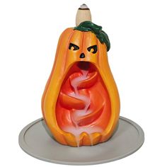 an orange and white pumpkin shaped candle holder with a face on it's head