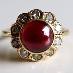 This dramatic ring demand an evening on the town. 0.67 carats of hand faceted diamonds are paired with an oversized cabochon garnet and set in 14k gold. Ring size ranges from 5-8. Garnet And Diamond Ring, Winter Jewelry, Jane Seymour, Citrine Earrings, Medieval Jewelry, Red Jewelry, Garnet Jewelry, White Jewelry, Hand Made Jewelry