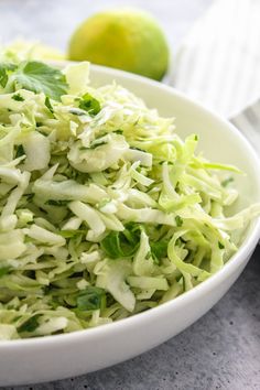 a white bowl filled with shredded green vegetables