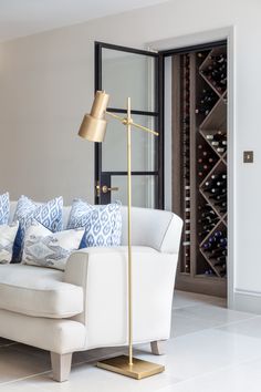 a living room filled with furniture and a wine rack