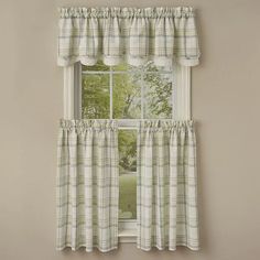 a window with a curtain and some curtains hanging on the side of it in front of a