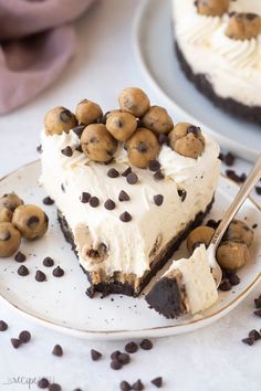 a piece of chocolate chip cookie doughnut cheesecake on a plate with a fork