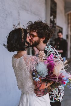 a man and woman kissing on the street