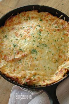 a cheesy dish in a cast iron skillet