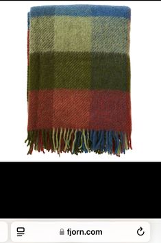 a plaid blanket with fringes on the bottom and green, red, blue, and yellow colors