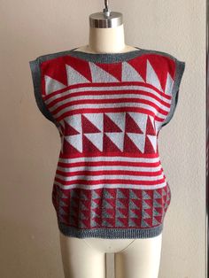 Rad 80s geometric sweater shirt/vest, maroon and gray colors. No tags but fits like a women's size small/medium. Shown here on a size 4 mannequin. Use measurements below for reference. A small discoloration spot (unnoticeable) shown in last photo. Measurements laying flat: 18.5 inches pit y 20.5 inches collar to hem Thanks for looking :) Fall Cotton Stretch Sweater Vest, Retro Fall Layering Tops, Fitted Cotton Sweater Vest For Layering, Fitted Cotton Sweater Vest For Winter, Winter Cotton Fitted Sweater Vest, Winter Fitted Cotton Sweater Vest, Retro Jacquard Knit Tops For Spring, Fitted Winter Sweater Vest, Sleeveless Jacquard Knit Top For Fall