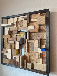 a wooden wall sculpture made out of wood blocks