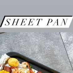 a sheet pan filled with shrimp, corn and potatoes