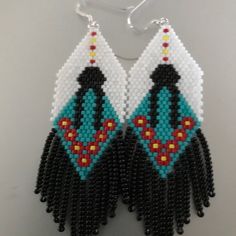 the beaded earrings are designed with black and white beads, which have colorful designs on them