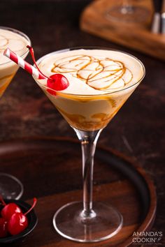 two martinis sitting on top of a wooden table