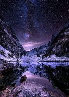 the night sky is reflected in a mountain lake