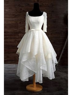 a white dress on a mannequin stand