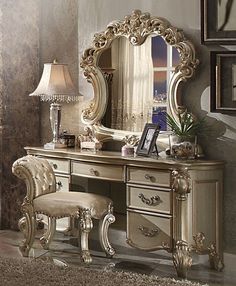 an antique style dressing table with mirror and stool