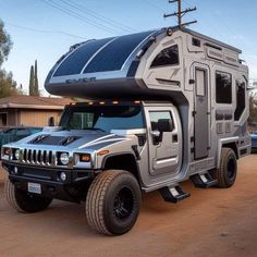 a silver truck with a camper attached to it