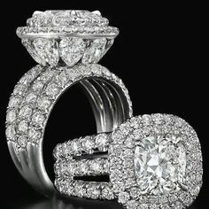 an engagement ring with two halos and diamonds on it, in front of a black background