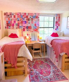 two beds in a room with a rug on the floor and a table next to them