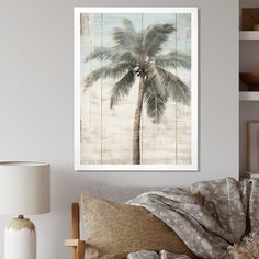 a palm tree in front of a white wall with a wooden planks as the background