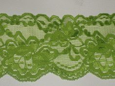 a green lace with flowers on it