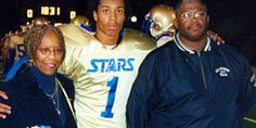 three people standing next to each other in front of a football field with helmets on