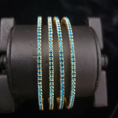 "* Handcrafted Gold Plated 4 Bangle Set. Sold as a set. * Bangles with high quality blue stones. * High Quality 22K Gold Plated. Bangles Sizes : 2.4 ( 2.20\" diameter of the inner circle) ; 2.6 ( 2.40\" diameter of the inner circle); 2.8 (2.50\" diameter of the inner circle) The gorgeous gold-plated bangles set best exemplifies the careful craftsmanship done on it -- specially picked for you by Nemali Jewelry. It has a special tone of elegance attached to it. The intricate handmade design of the Blue Bangle Bracelet For Wedding, Blue Bangle Bracelets For Wedding, Blue Round Beaded Bracelets For Wedding, Adjustable Round Blue Bangle, Blue Stackable Round Bracelets, Festive Blue Round Bangle, Blue Hand Set Bangle For Wedding, Blue Hand-set Bangle For Wedding, Blue Festive Bangle Jewelry